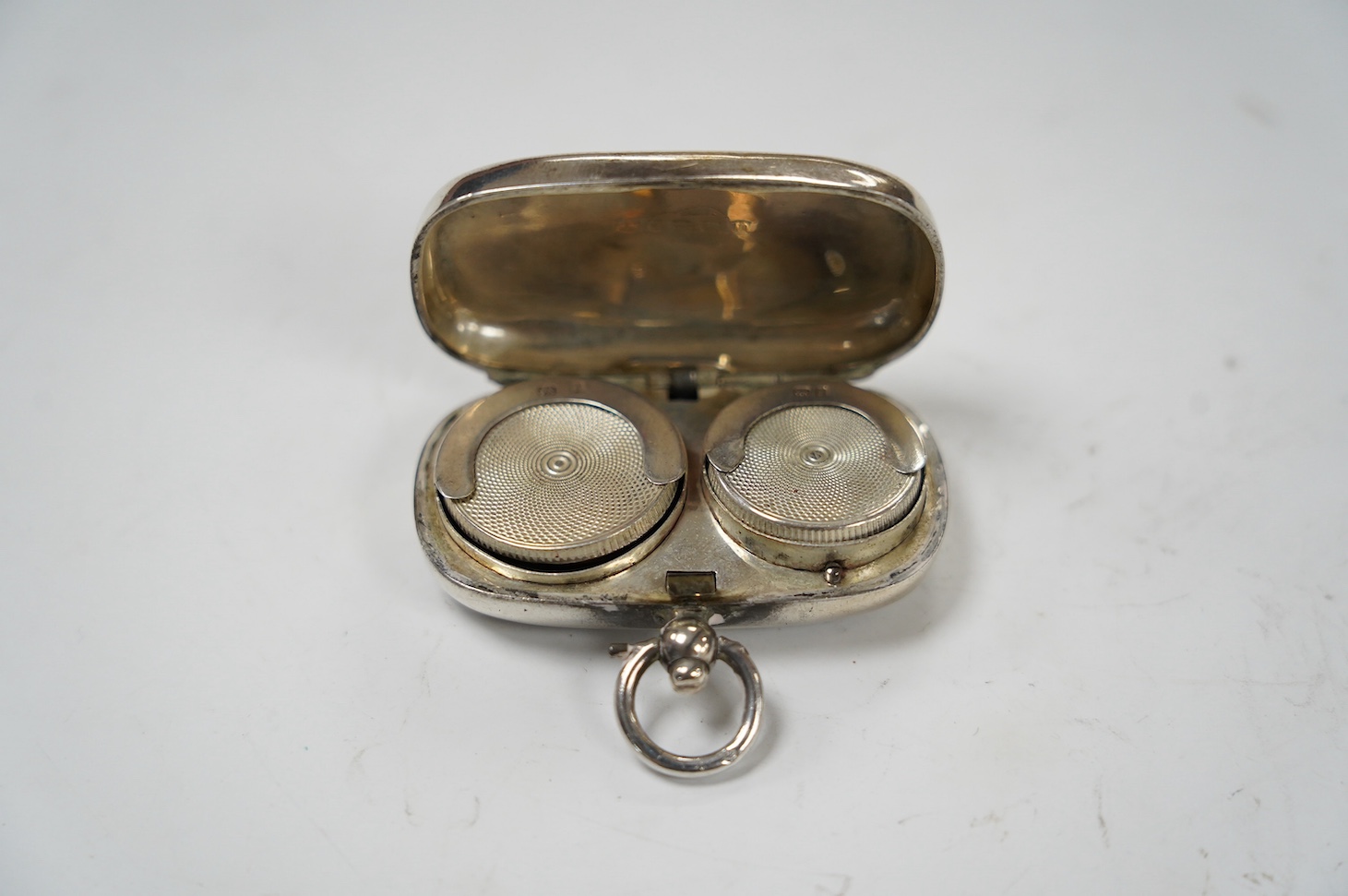 A George V engraved silver sovereign/half sovereign case, Birmingham 1910, 50mm. Condition - fair